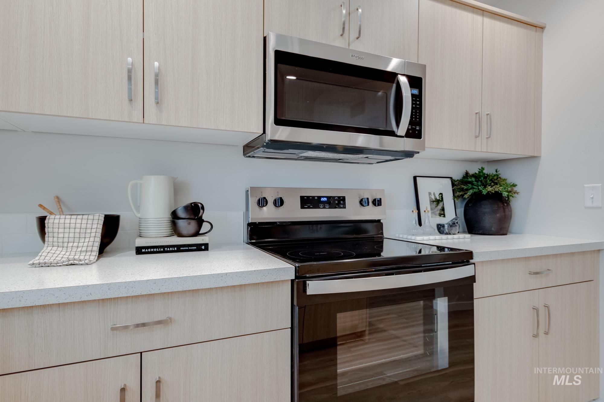 1776 West Unforgettable Street Meridian, ID 83642 - Photo 7 of 27 Kitchen with light brown cabinets, stainless steel appliances, and modern cabinets
