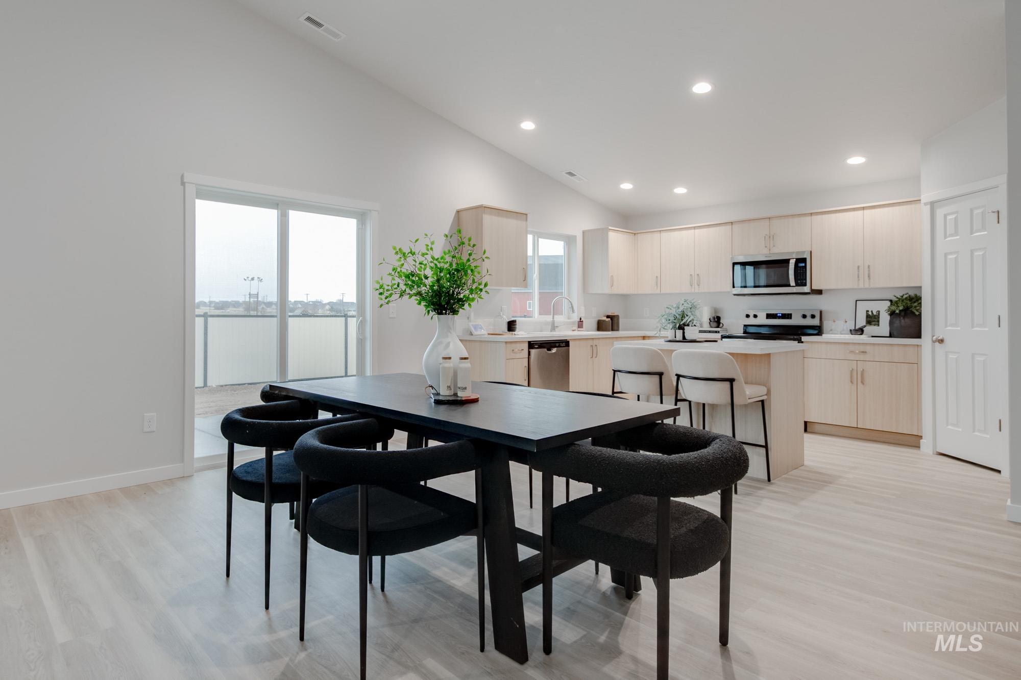 1776 West Unforgettable Street Meridian, ID 83642 - Photo 10 of 28 Dining space featuring recessed lighting, light wood-style flooring, and high vaulted ceiling