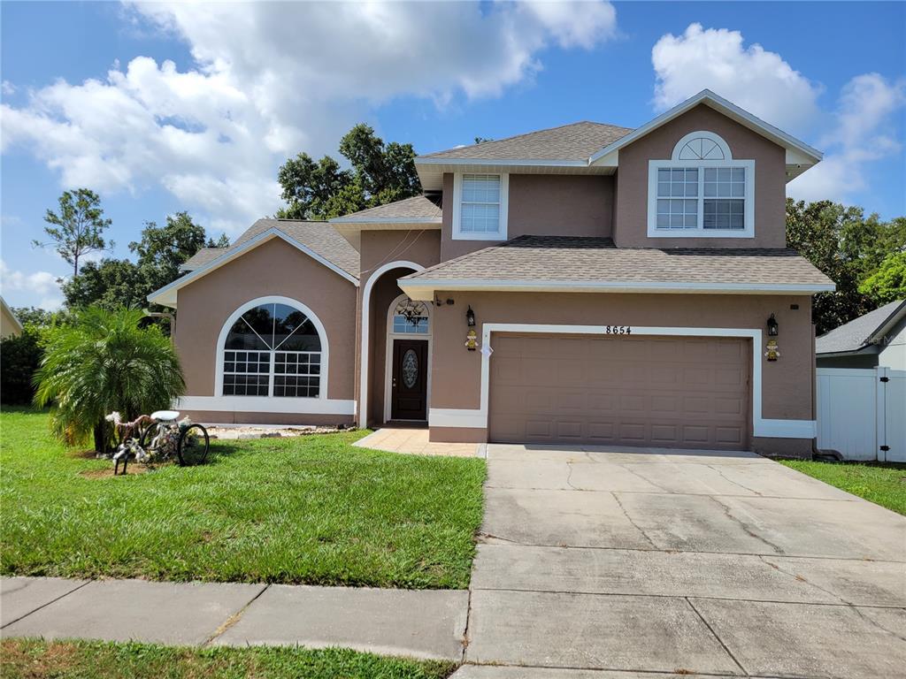 a front view of a house with a yard and garage