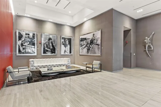 a bedroom with a bed and painting on the wall