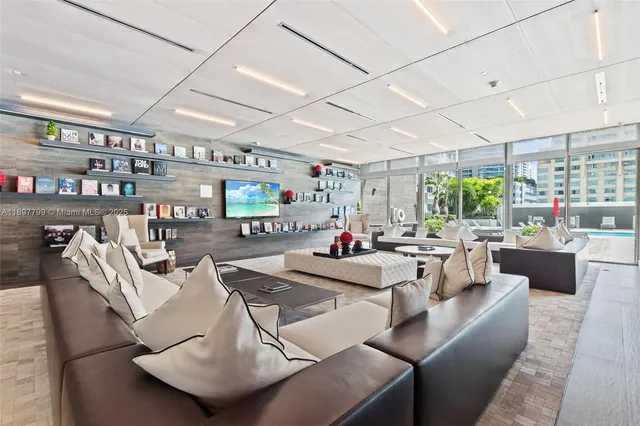 a living room with lots of furniture and a chandelier