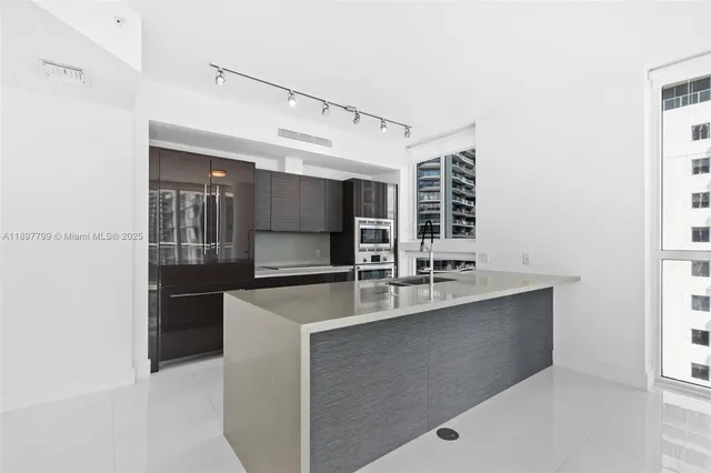 a kitchen with stainless steel appliances a sink and a microwave