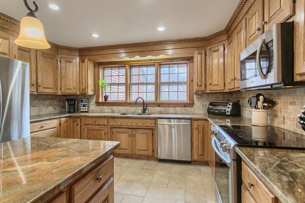 2 Ryan Road Townsend, MA 01474 - Photo 14 of 30 a kitchen with stainless steel appliances granite countertop a sink stove and refrigerator