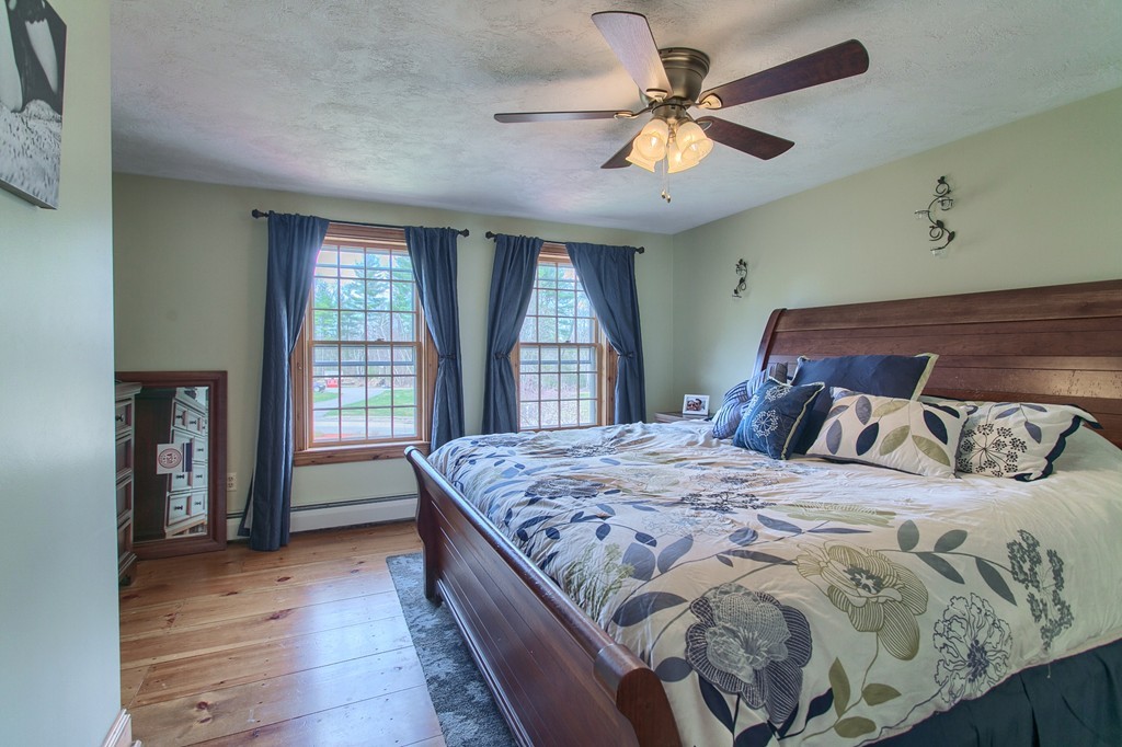 2 Ryan Road Townsend, MA 01474 - Photo 18 of 30 a bedroom with a large bed and a chandelier