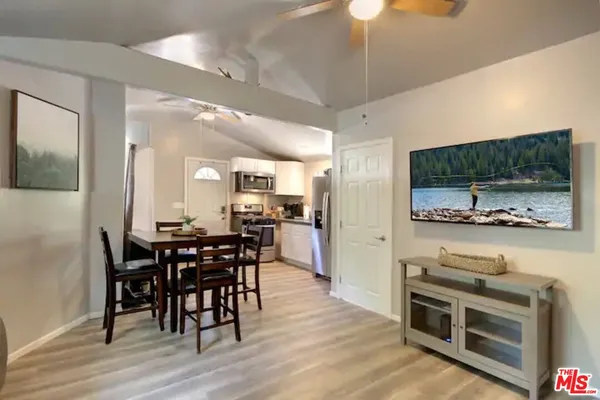a view of a dining room with furniture wooden floor and flat screen tv