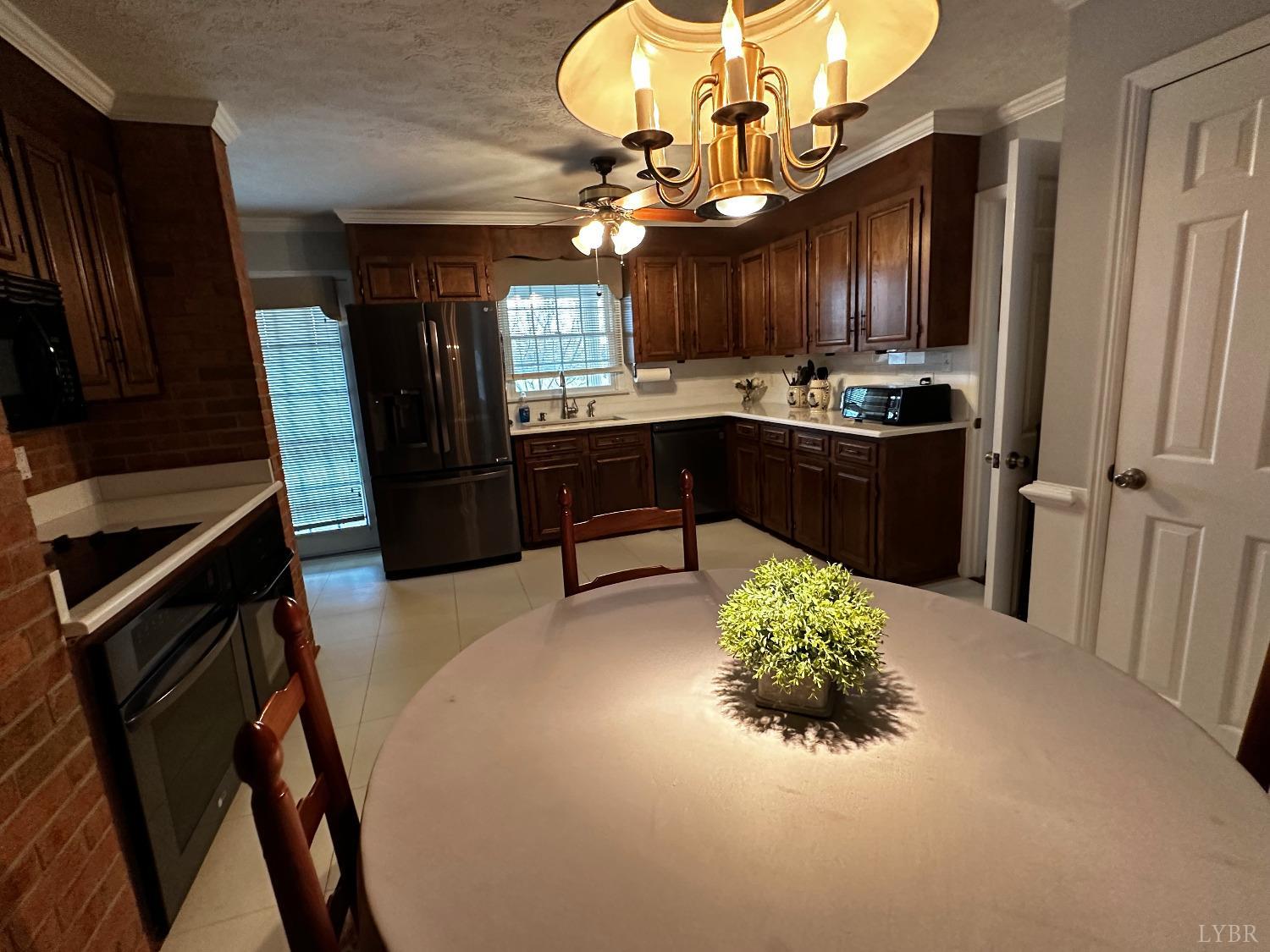 1687 Pilgrim Road Forest, VA 24551 - Photo 11 of 42 a kitchen with a refrigerator and a wooden floor