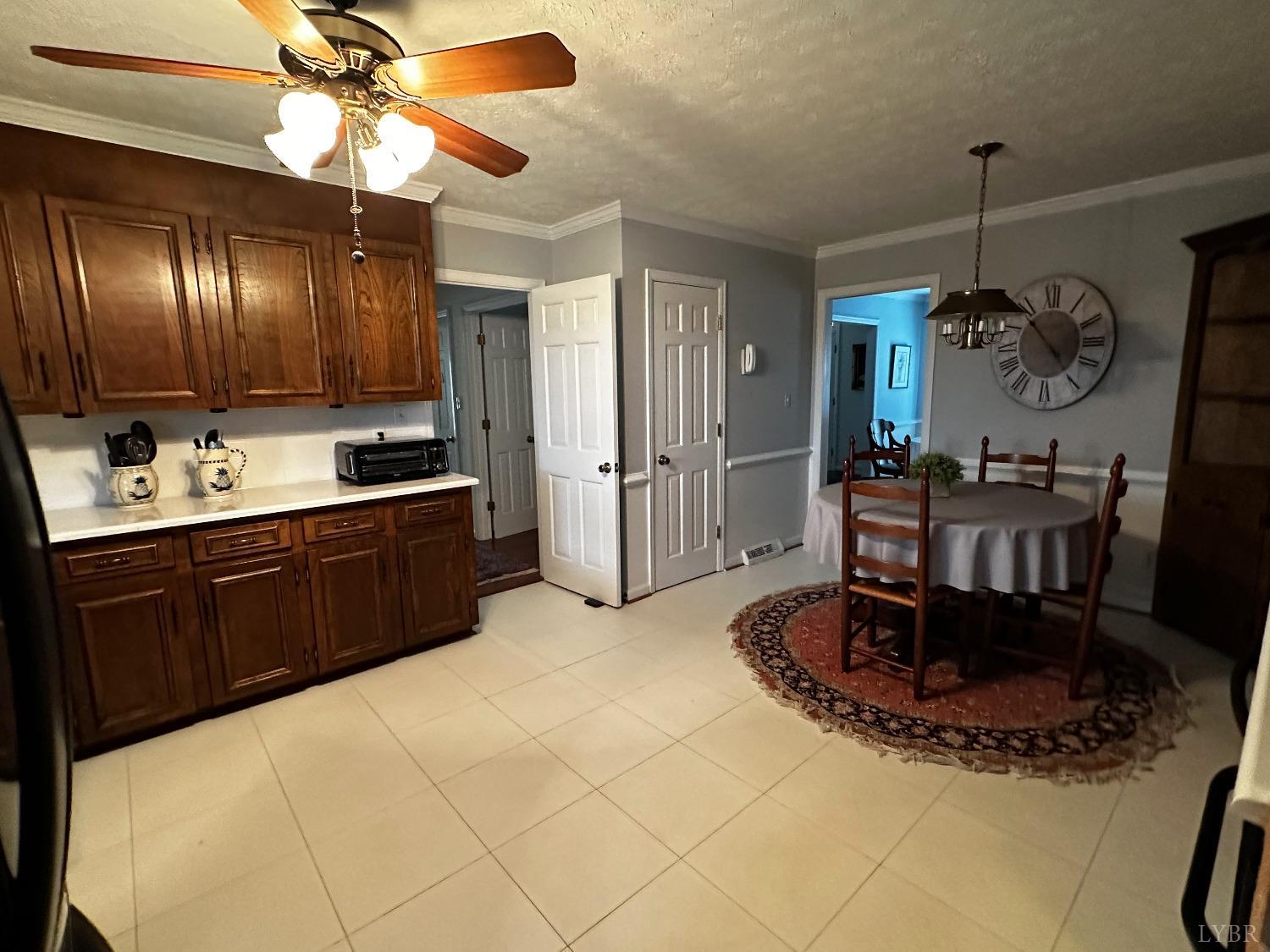 1687 Pilgrim Road Forest, VA 24551 - Photo 10 of 42 a kitchen with a table and a chandelier