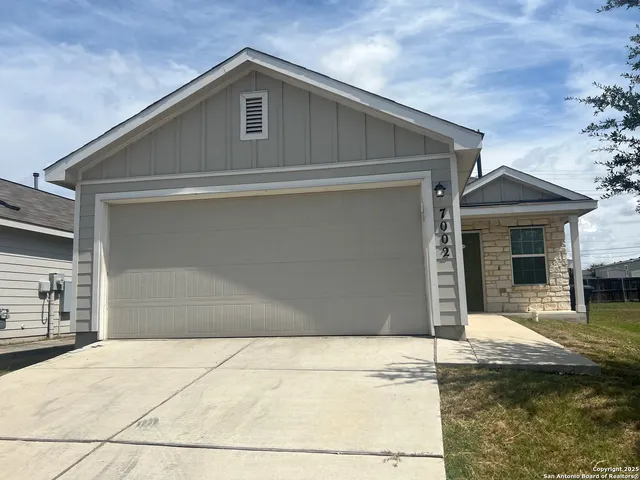 a front view of a house with garage