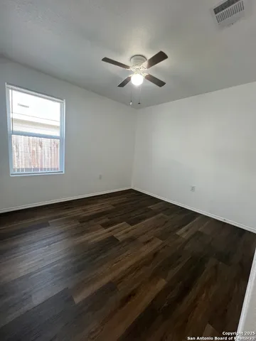 a bathroom with a granite countertop toilet sink and mirror