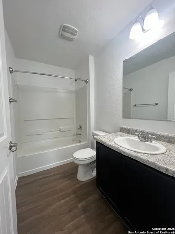 an empty room with wooden floor and a window