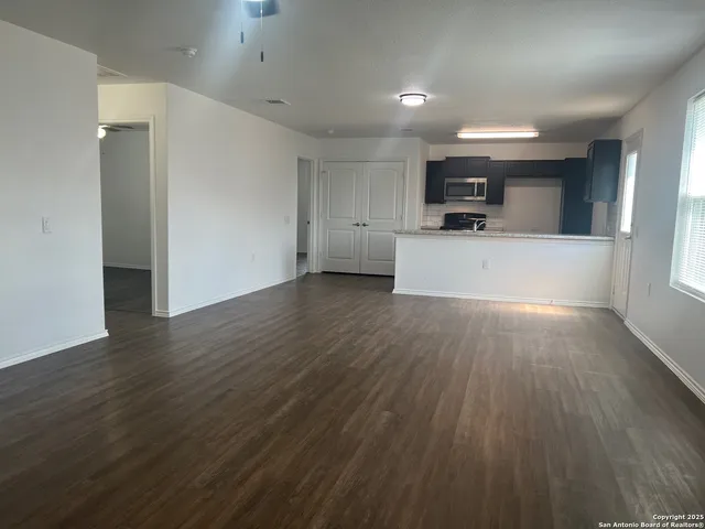 a view of a kitchen with a sink and a refrigerator