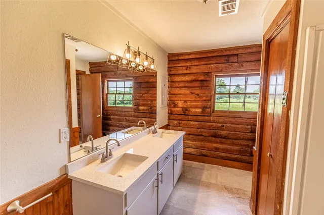 a bathroom with a sink vanity and a mirror