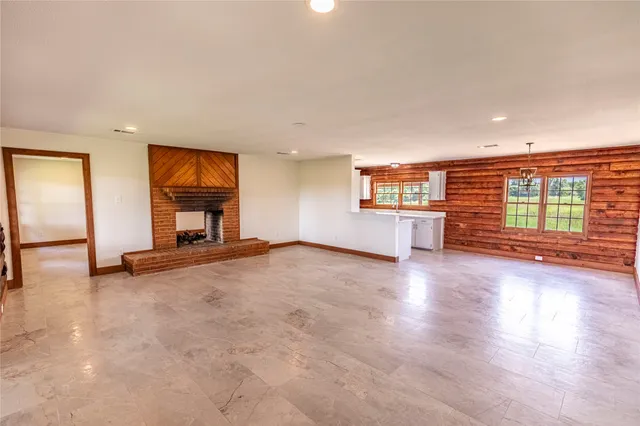an empty room with furniture and a fireplace