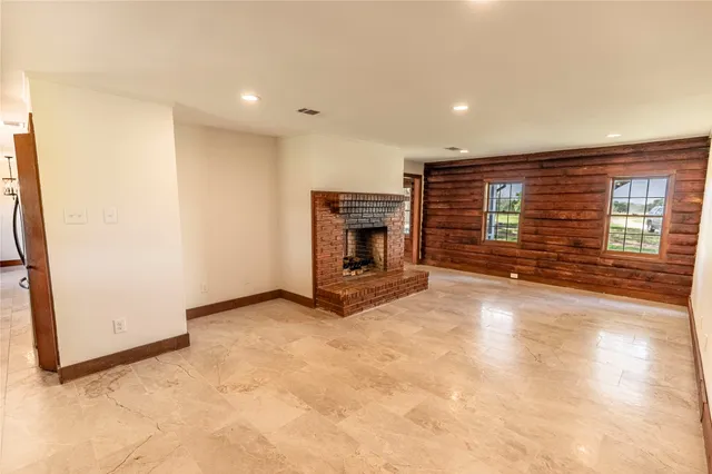 a view of an empty room with a fireplace