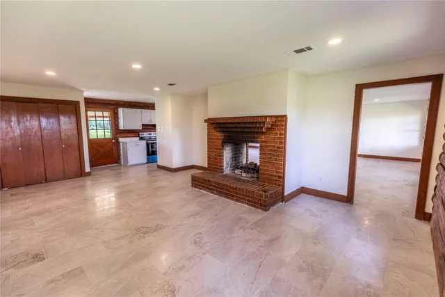 an empty room with furniture and a fireplace