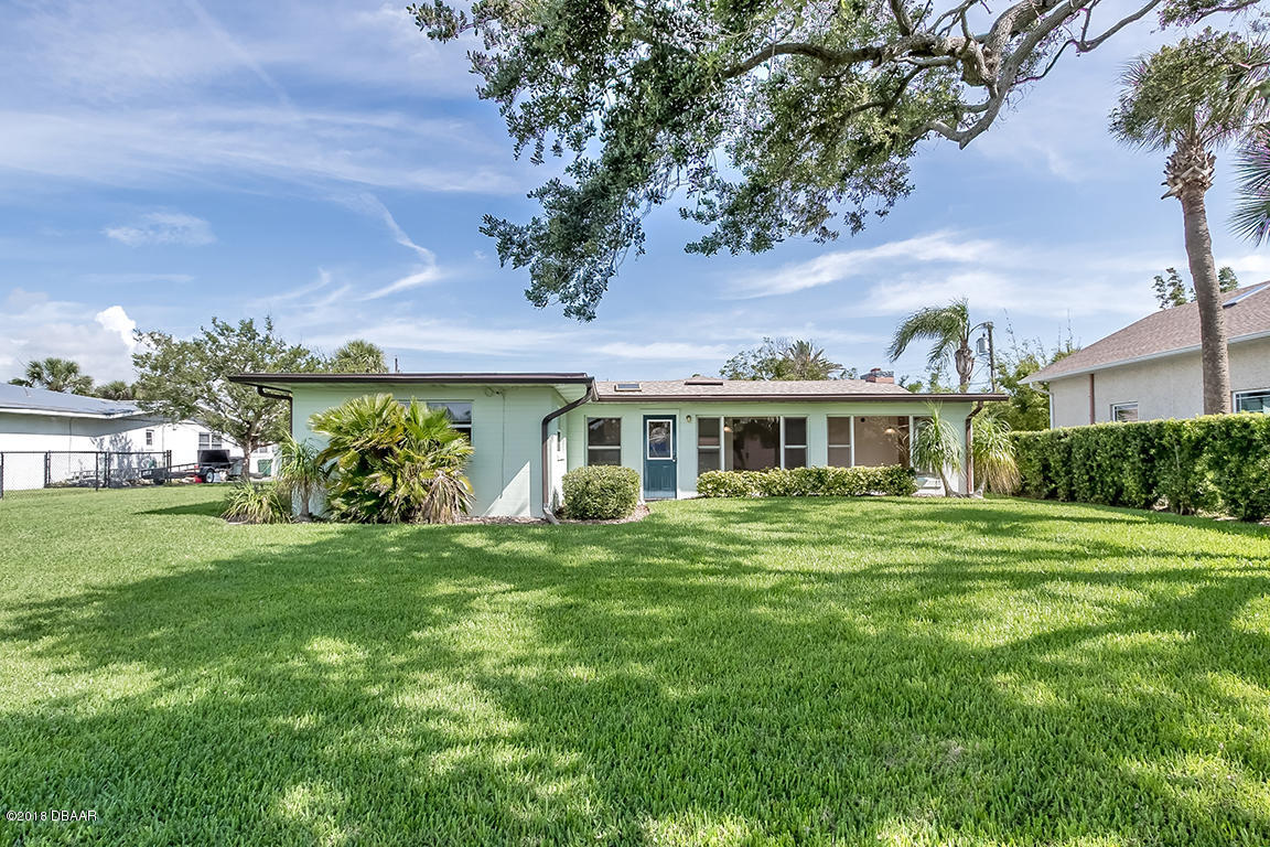 137 Reef Road South Daytona, FL 32119 - Photo 12 of 49 a front view of a house with a garden