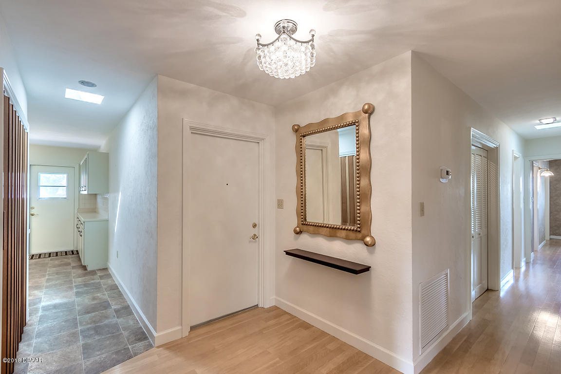137 Reef Road South Daytona, FL 32119 - Photo 13 of 49 a view of a hallway with wooden floor and staircase
