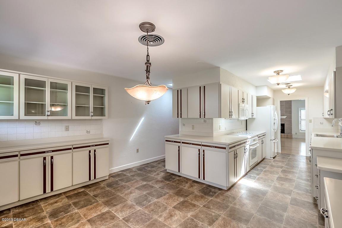 137 Reef Road South Daytona, FL 32119 - Photo 14 of 49 a kitchen with stainless steel appliances granite countertop a stove and a sink