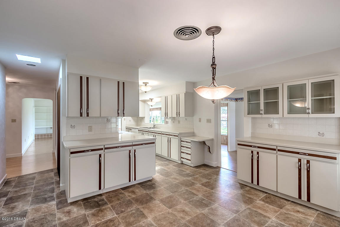 137 Reef Road South Daytona, FL 32119 - Photo 15 of 49 a kitchen with a stove a sink and a refrigerator