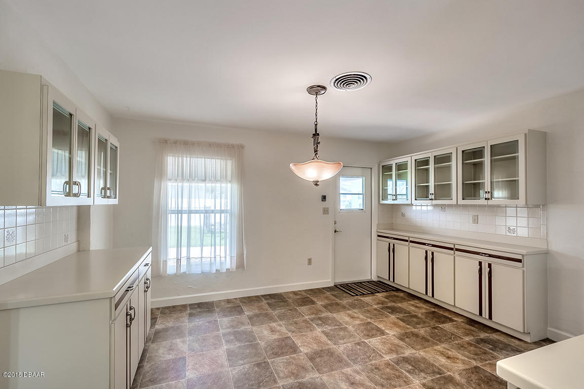 137 Reef Road South Daytona, FL 32119 - Photo 16 of 49 a view of an empty room with window and wooden floor