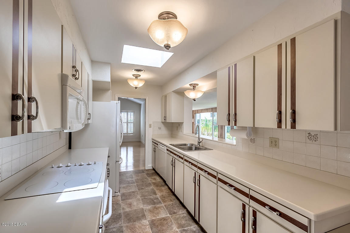 137 Reef Road South Daytona, FL 32119 - Photo 18 of 49 a kitchen with a sink and refrigerator