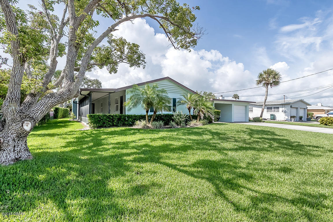 137 Reef Road South Daytona, FL 32119 - Photo 2 of 49 a front view of a house with a garden