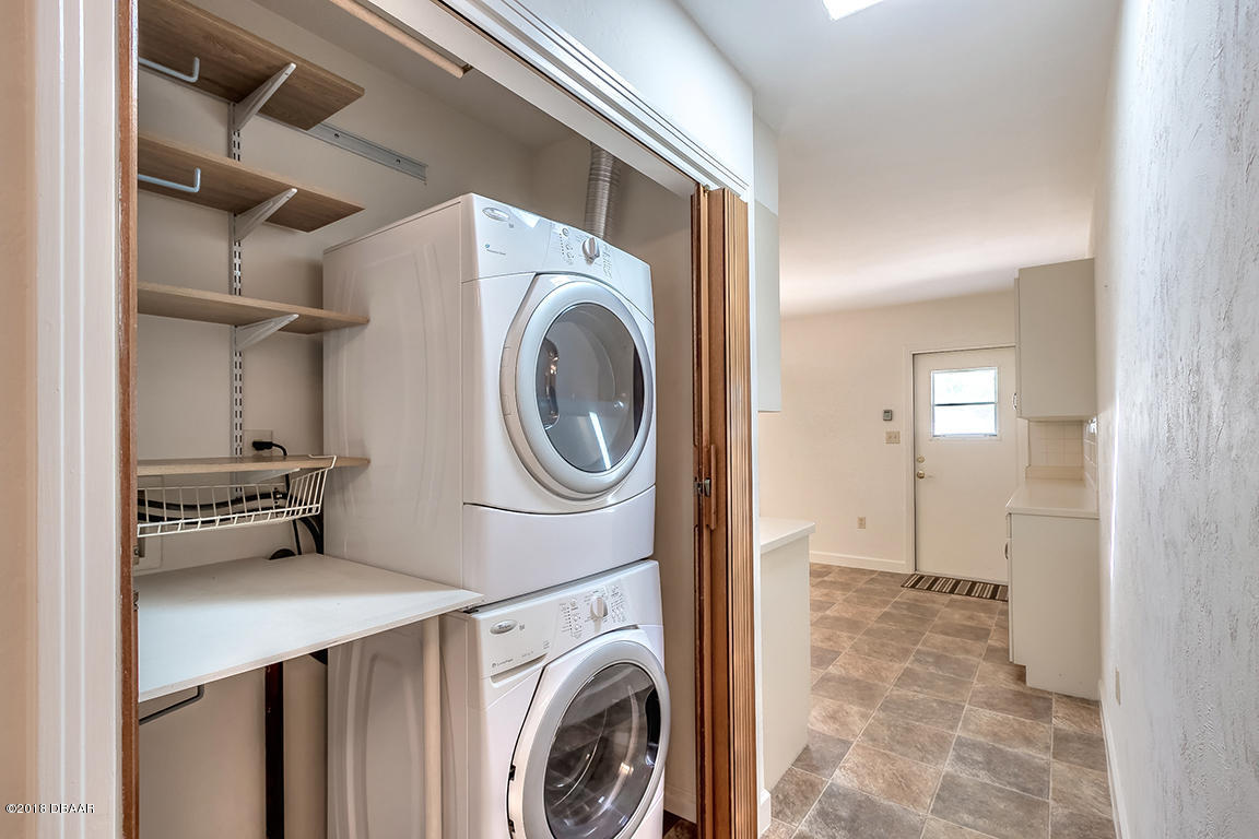 137 Reef Road South Daytona, FL 32119 - Photo 21 of 49 a view of a storage & utility room with dryer and washer