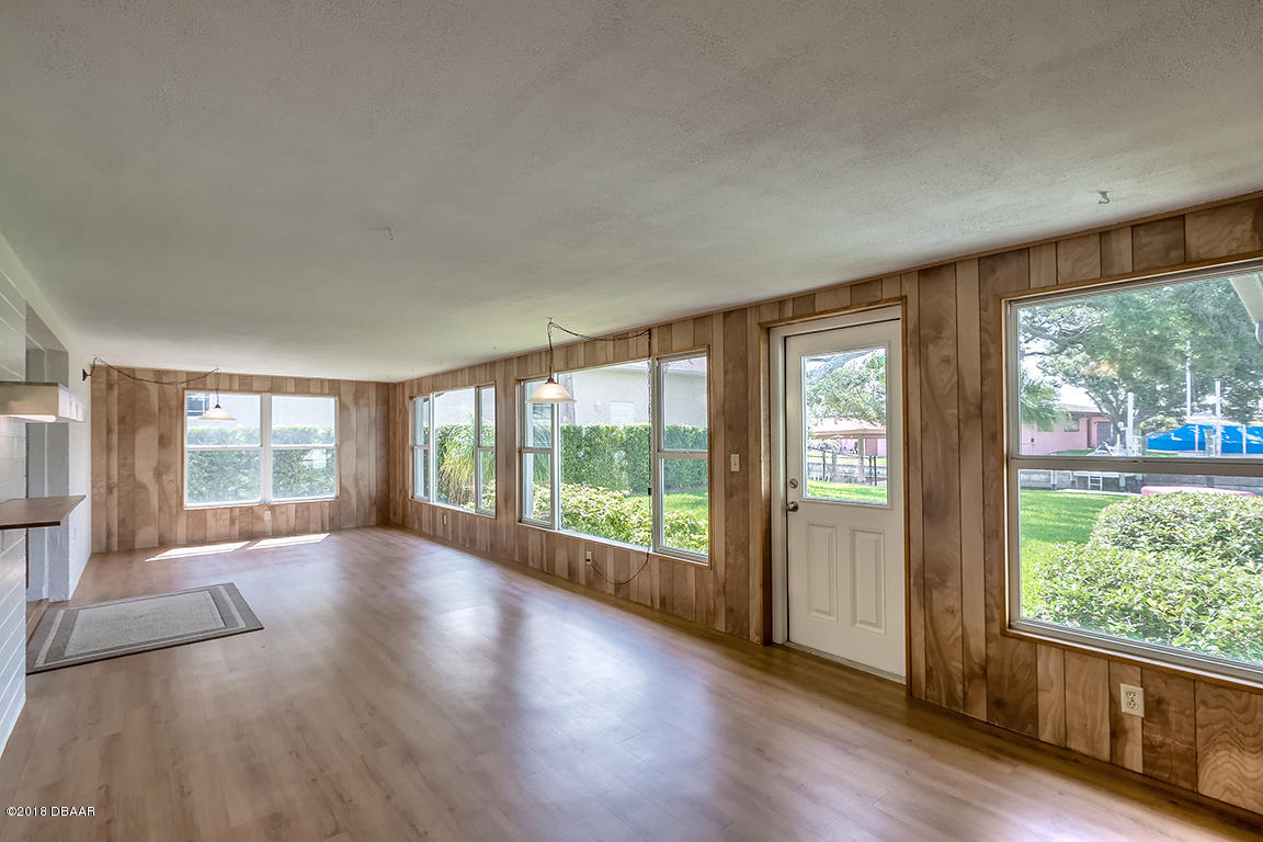 137 Reef Road South Daytona, FL 32119 - Photo 25 of 49 an empty room with wooden floor and balcony