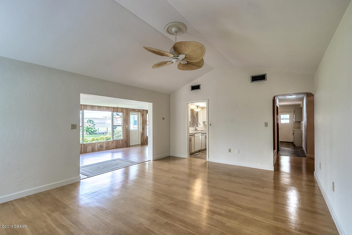 137 Reef Road South Daytona, FL 32119 - Photo 26 of 49 a view of an empty room with wooden floor and a window