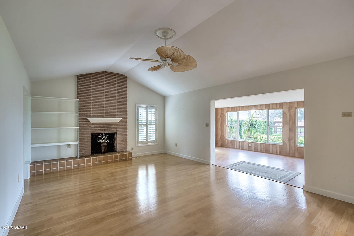 137 Reef Road South Daytona, FL 32119 - Photo 27 of 49 an empty room with windows fireplace and windows