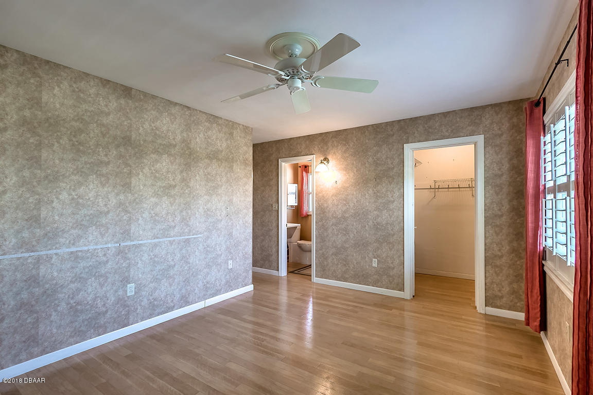 137 Reef Road South Daytona, FL 32119 - Photo 30 of 49 a view of an empty room with wooden floor and a window