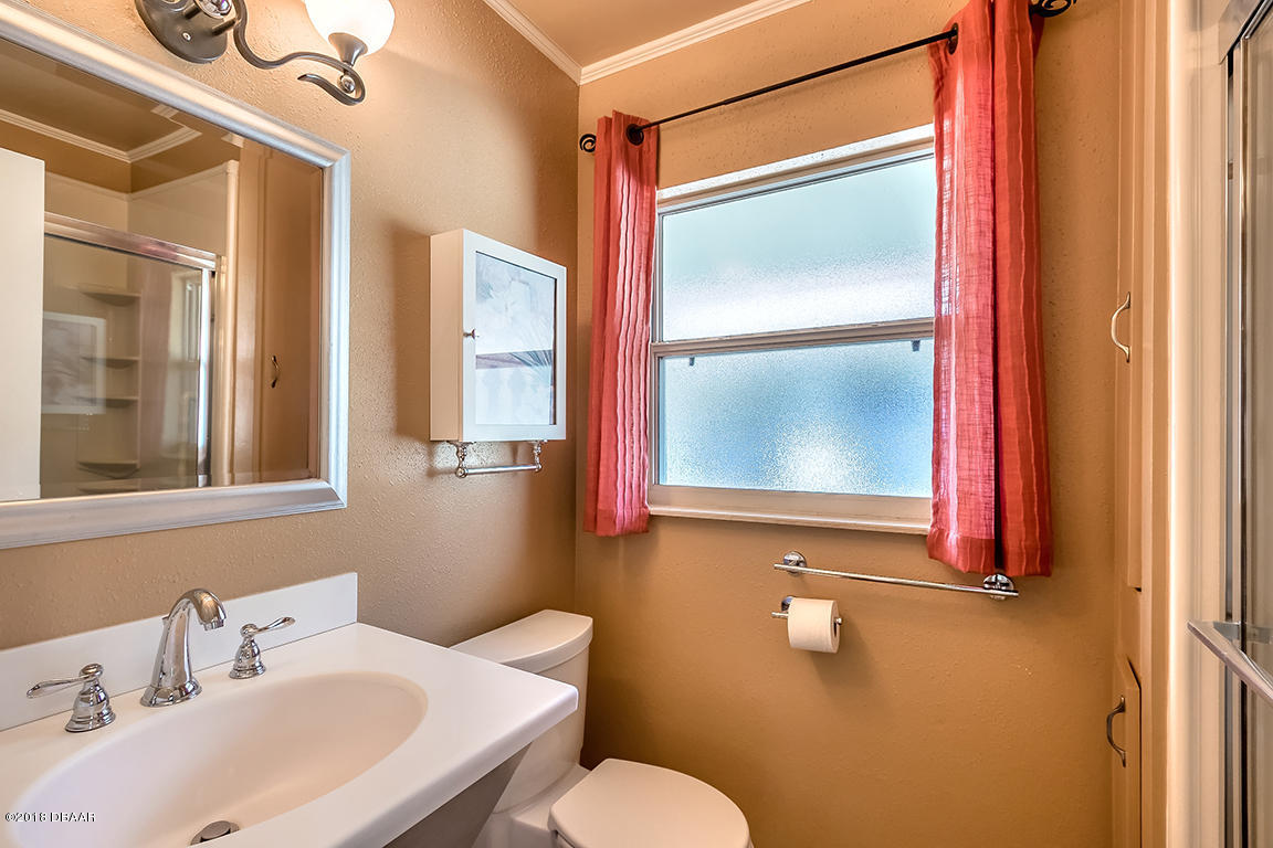 137 Reef Road South Daytona, FL 32119 - Photo 31 of 49 a bathroom with a sink and mirror with toilet