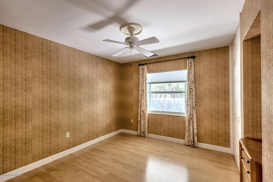 137 Reef Road South Daytona, FL 32119 - Photo 32 of 49 a view of an empty room with window and chandelier fan