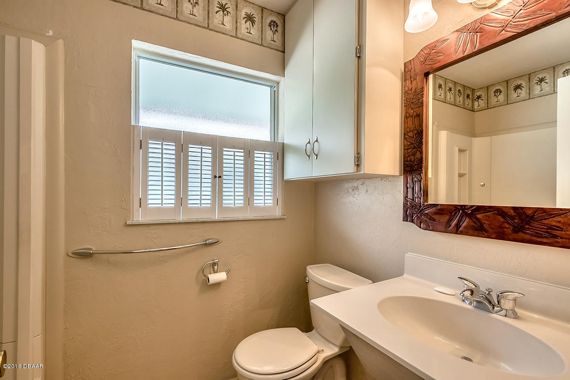 137 Reef Road South Daytona, FL 32119 - Photo 34 of 49 a bathroom with a sink and a toilet