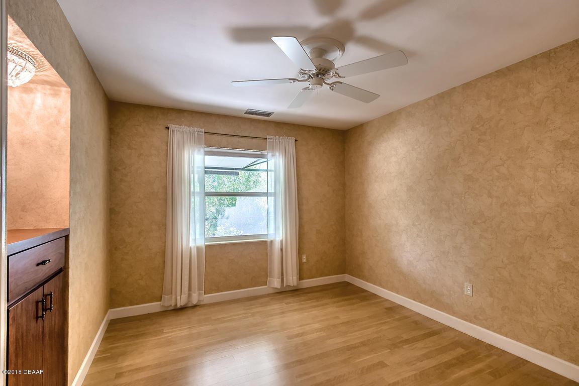 137 Reef Road South Daytona, FL 32119 - Photo 35 of 49 an empty room with a window and wooden floor