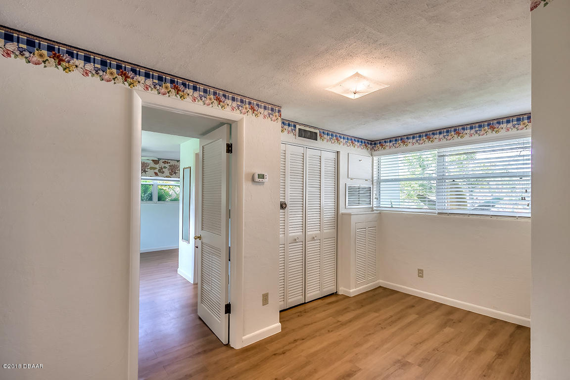 137 Reef Road South Daytona, FL 32119 - Photo 37 of 49 a view of an empty room with wooden floor and a window