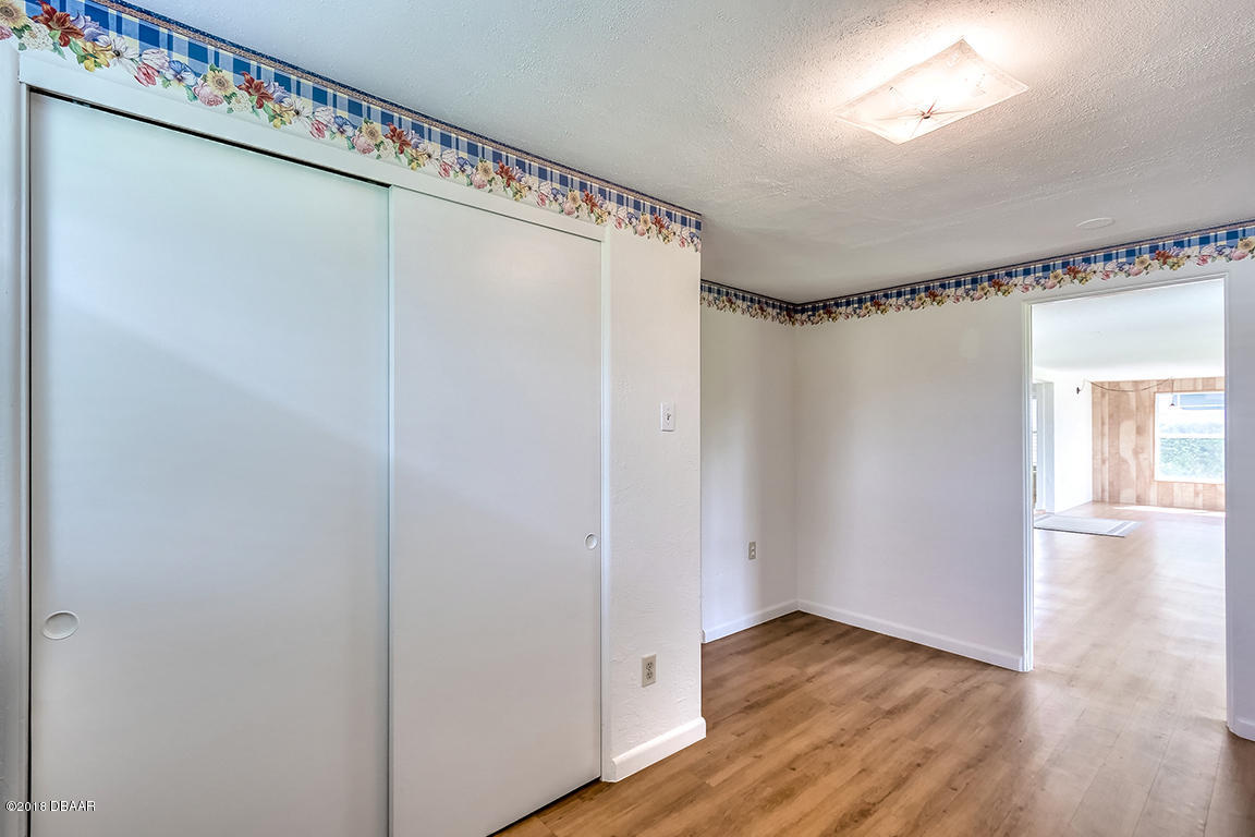 137 Reef Road South Daytona, FL 32119 - Photo 38 of 49 a view of an empty room with wooden floor