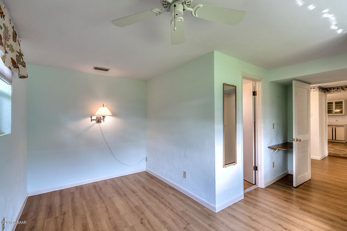 137 Reef Road South Daytona, FL 32119 - Photo 40 of 49 wooden floor in an empty room with a window
