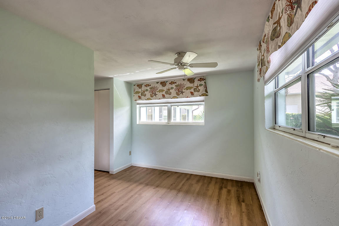 137 Reef Road South Daytona, FL 32119 - Photo 41 of 49 a view of an empty room with wooden floor and a window