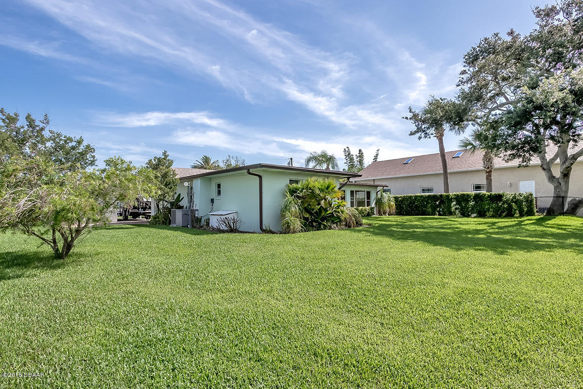 137 Reef Road South Daytona, FL 32119 - Photo 48 of 49 a view of a house with a big yard plants and large trees