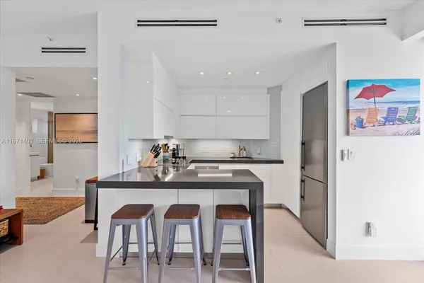 a kitchen with a sink dishwasher and cabinets