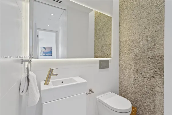 a bedroom with a bed and a refrigerator