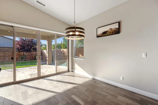 a living room with a large window and a chandelier