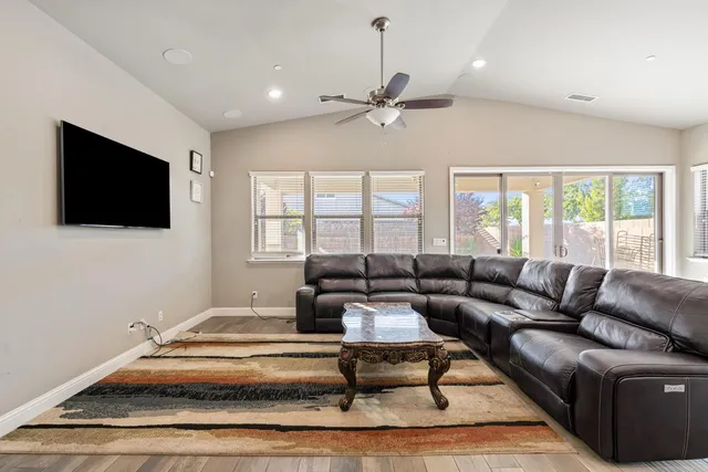 a living room with furniture a chandelier and a piano