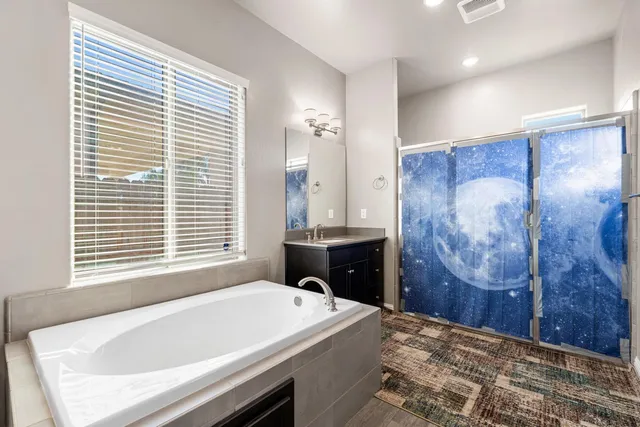 a bathroom with a double vanity sink and a mirror