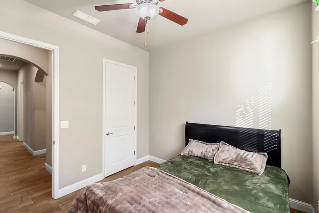 a bedroom with a bed and a chandelier