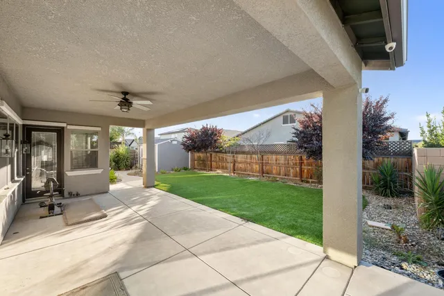 a view of a house with backyard and porch
