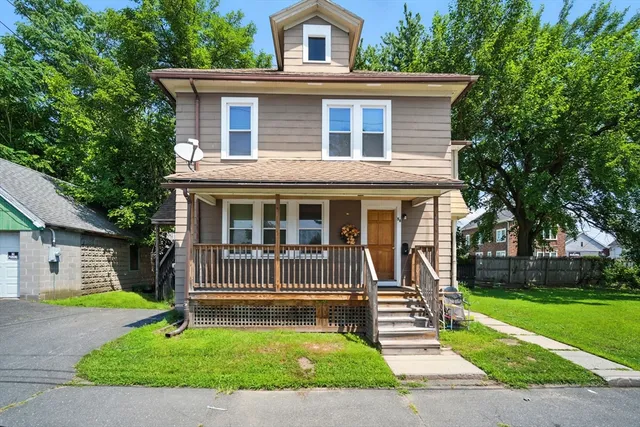 a front view of a house with a yard and porch