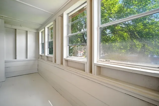 a view of room with window and front door