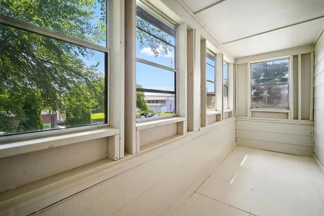 a view of an entryway with wooden floor and windows